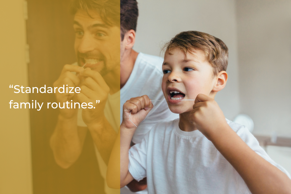 A man and a young boy stand side by side in a bathroom, both flossing their teeth, with the text “Standardize family dental resolutions for better oral health in 2026.” displayed.